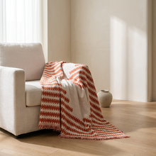 Chenille couch cover draped on sofa, white oak floor, soft morning light