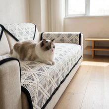 Ragdoll settling on the Carr covered sofa
